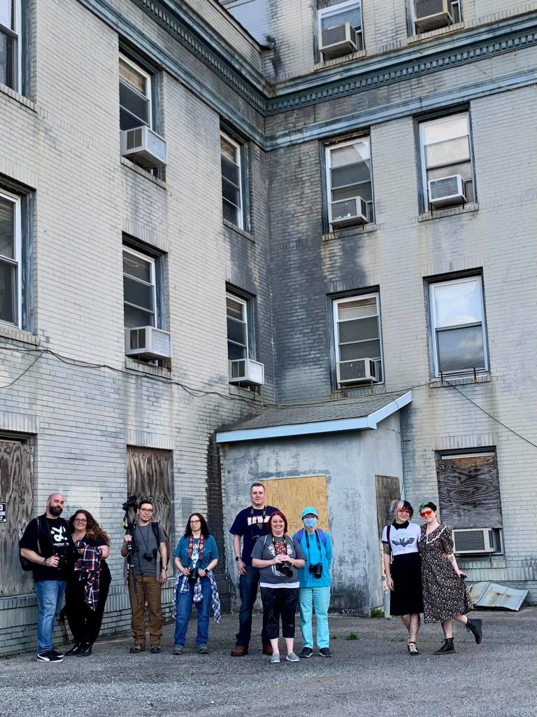This is a group photo in front of an old hospital.